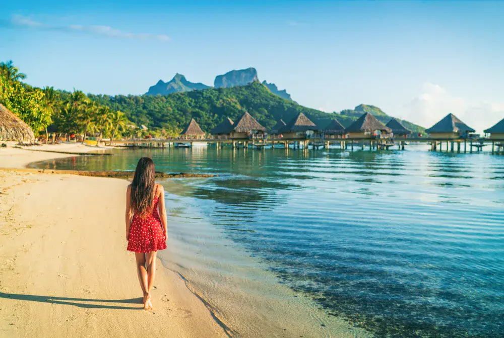Quiet morning along a sandy shore facing stilted villas