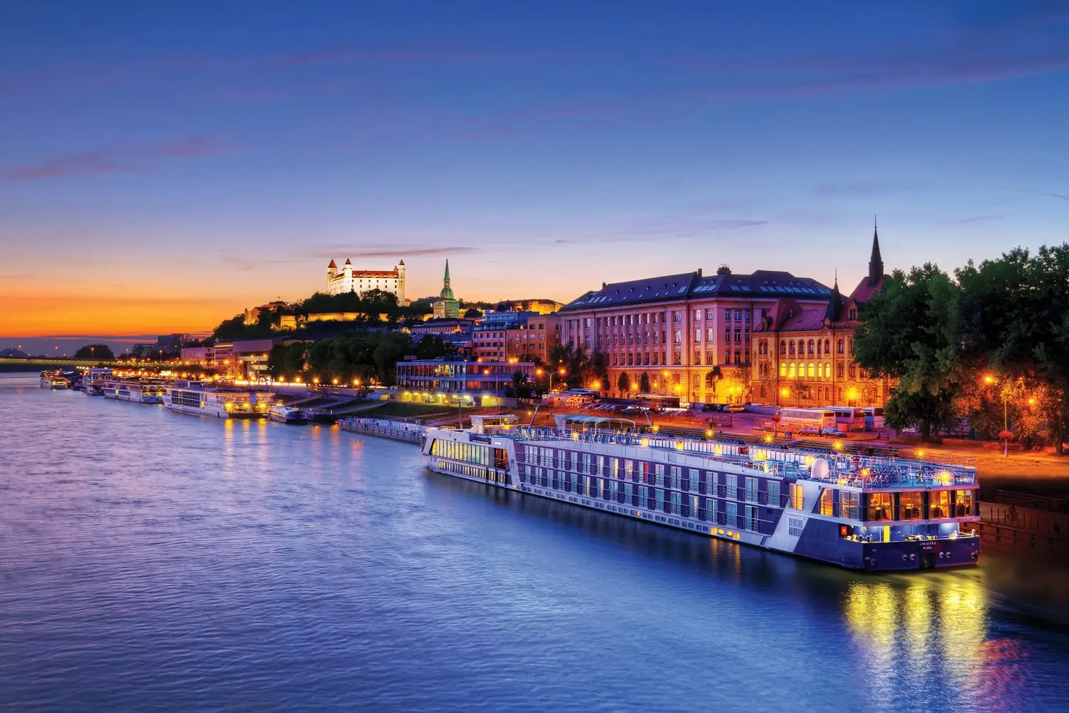 AMAWaterways river cruise ship sailing at golden hour